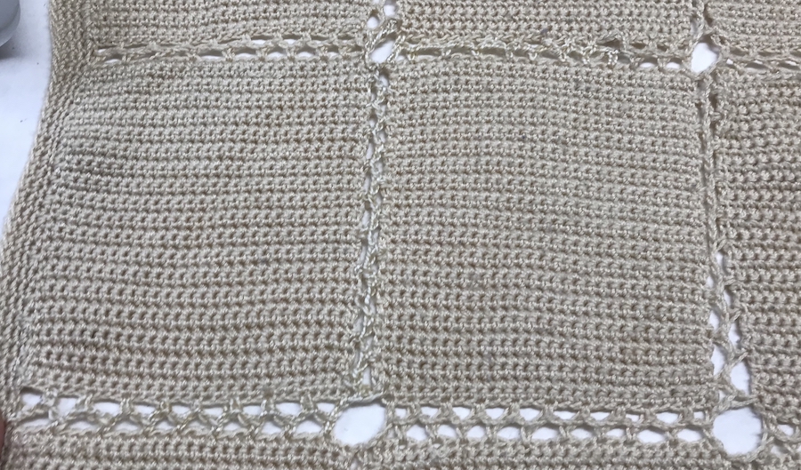 crocheted afghan blanket with repaired chain between blocks