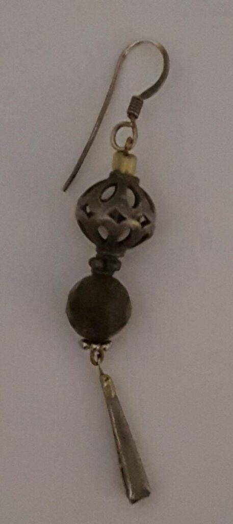 a single earring with a french wire, and beads of various sizes and materials