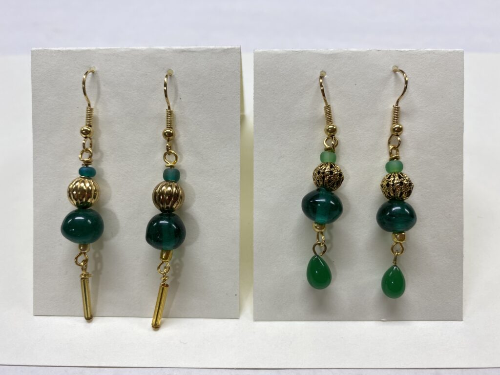 two pair of green & gold earrings on card backing